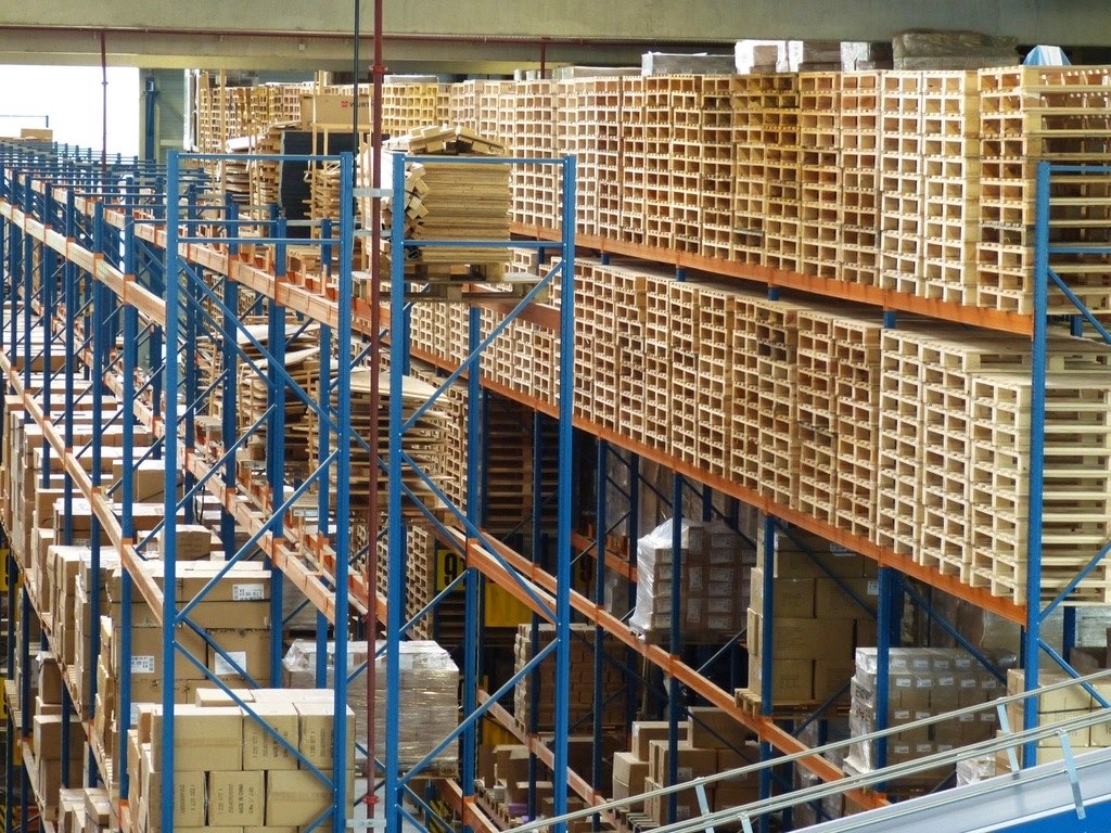 Warehouse aisle with shelving stacked with boxes